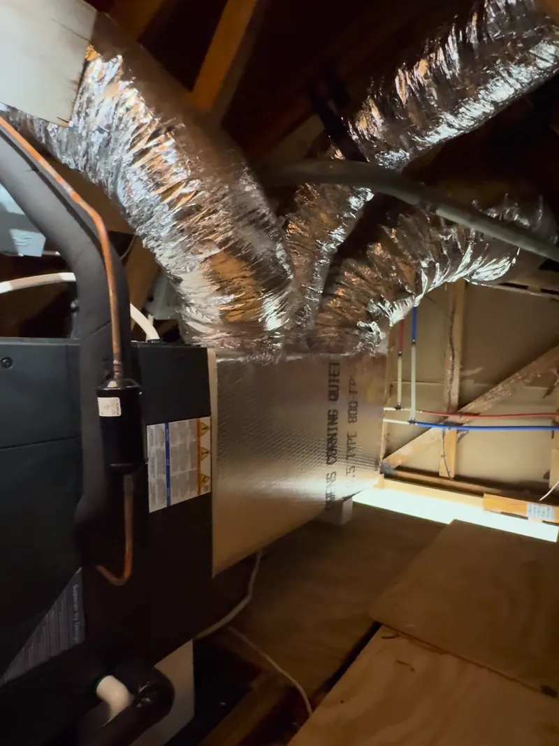 Trane air handler installed in an attic with new insulated flex ductwork and an insulated refrigerant line