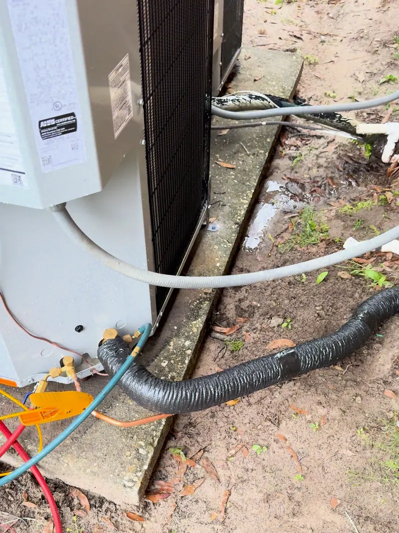 Refrigerant gauge hoses connected to an outdoor unit’s service valves
